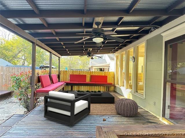 420 K St SW, Ardmore, OK 73401 - deck with a fenced backyard, a ceiling fan, and an outdoor living space