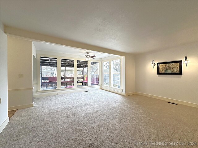 empty room with carpet floors and ceiling fan