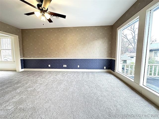 420 K St SW, Ardmore, OK 73401 - spare room with wallpapered walls, carpet flooring, and a ceiling fan
