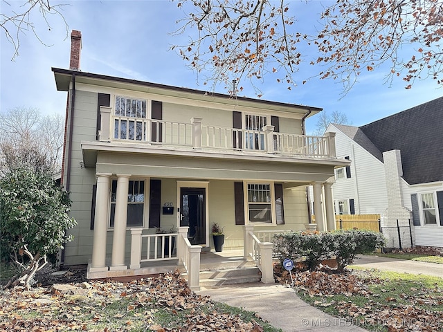 view of front of home with covered porch and a balcony