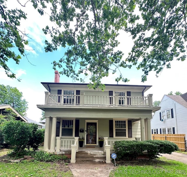 420 K St SW, Ardmore, OK 73401 - view of front facade with covered porch, a chimney, and a balcony