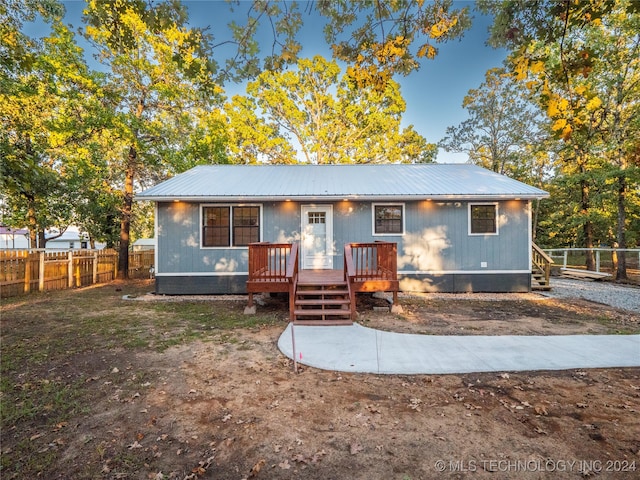 back of house with a wooden deck