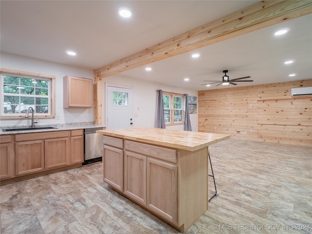 kitchen featuring a center island, ceiling fan, a healthy amount of sunlight, stainless steel dishwasher, and sink