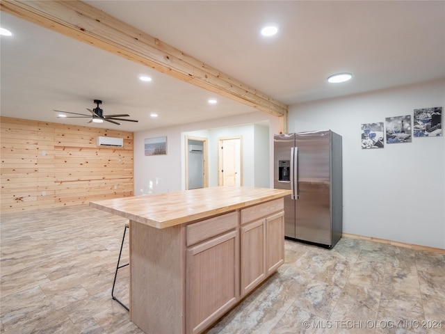 kitchen with stainless steel fridge with ice dispenser, wooden walls, light brown cabinets, ceiling fan, and butcher block countertops