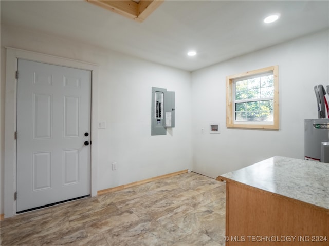 interior space featuring electric panel and water heater