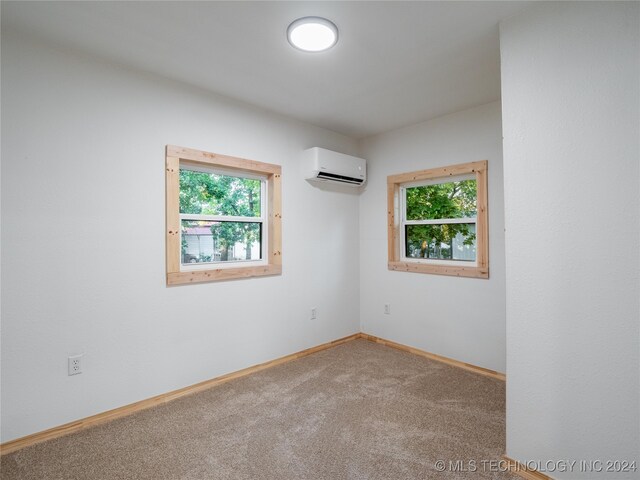 unfurnished room with a healthy amount of sunlight, carpet, and a wall unit AC