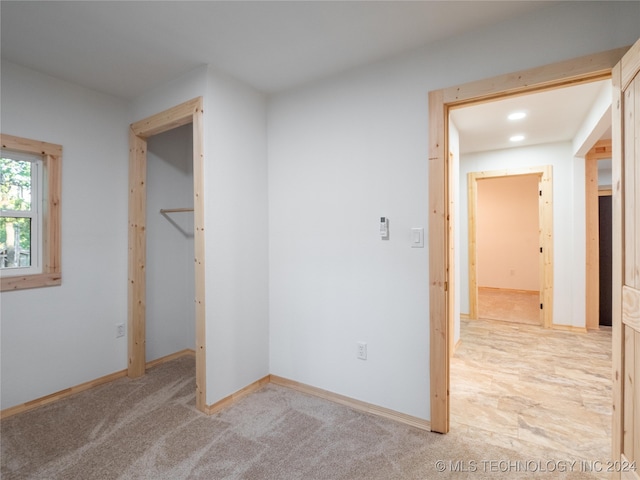 unfurnished bedroom with light carpet