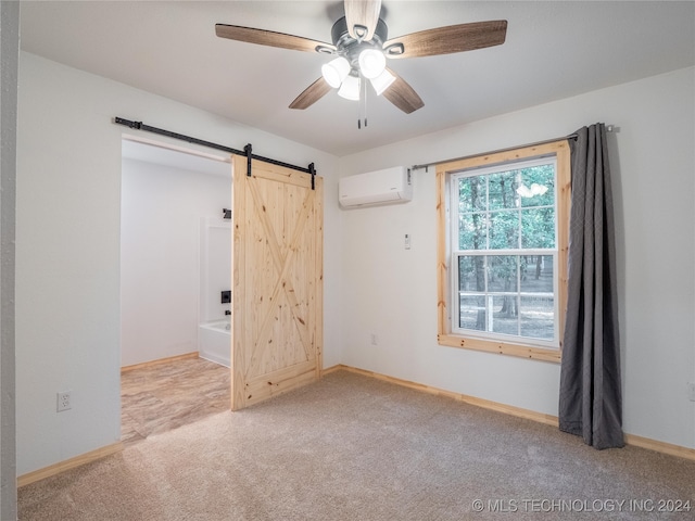 unfurnished bedroom with ceiling fan, a wall mounted air conditioner, light carpet, and a barn door