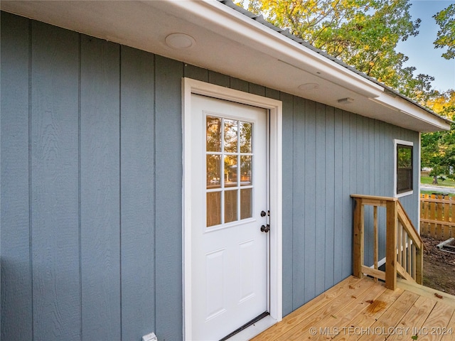 view of exterior entry with a deck