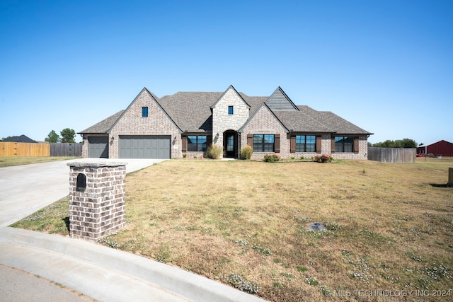 view of front of property featuring a front yard and a garage