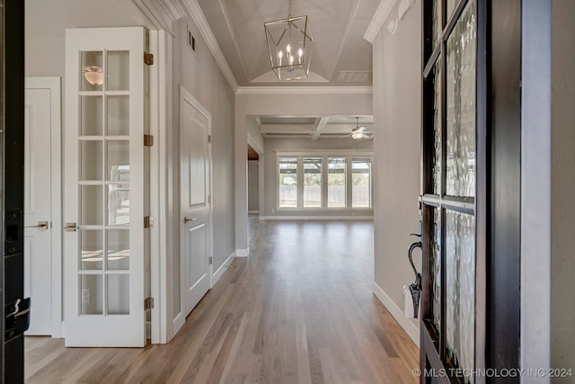 hallway featuring light hardwood / wood-style floors, beamed ceiling, coffered ceiling, an inviting chandelier, and ornamental molding