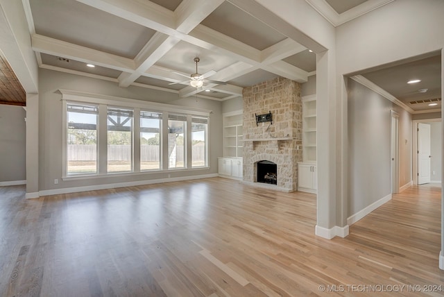 unfurnished living room with beam ceiling, coffered ceiling, a fireplace, light hardwood / wood-style flooring, and ceiling fan