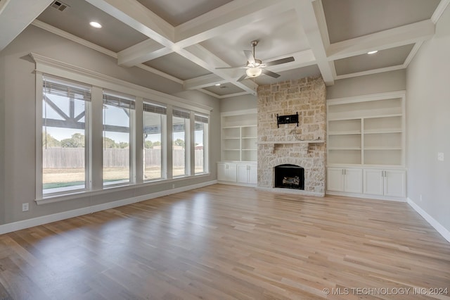 unfurnished living room featuring light hardwood / wood-style floors, beam ceiling, coffered ceiling, a fireplace, and ceiling fan