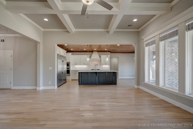 kitchen with custom exhaust hood, decorative light fixtures, light hardwood / wood-style floors, and white cabinetry