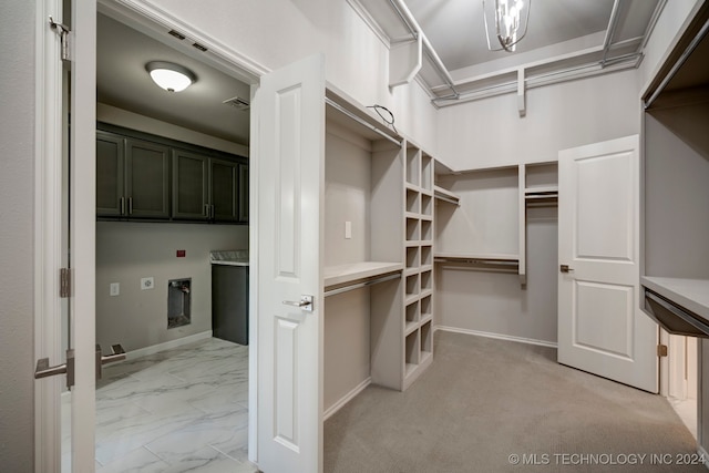 spacious closet with light colored carpet