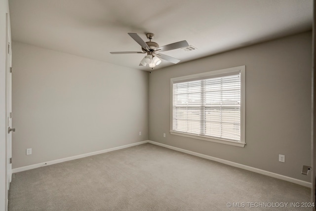 carpeted empty room featuring ceiling fan