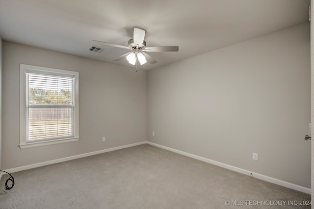 carpeted spare room with ceiling fan