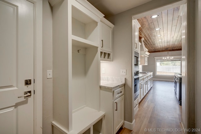 mudroom featuring a notable chandelier, wood ceiling, and light hardwood / wood-style floors