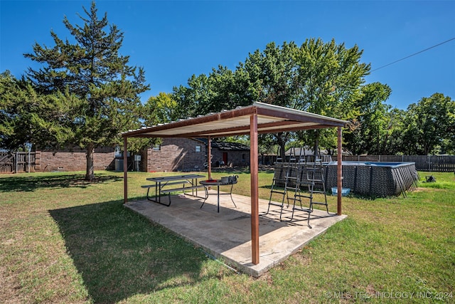 view of yard with a fenced in pool and a patio area