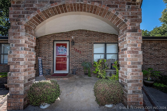 1202 N Pine St, Waurika, OK 73573 - doorway to property with brick siding