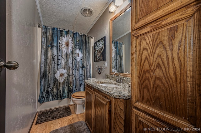 full bathroom featuring ornamental molding, vanity, hardwood / wood-style floors, and toilet