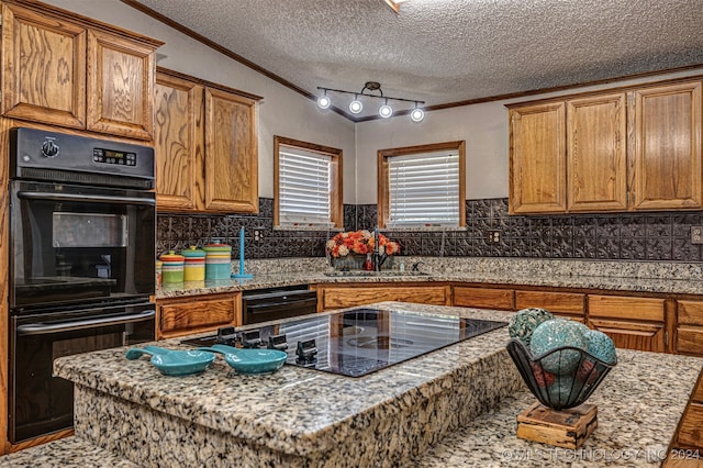 kitchen with ornamental molding, black appliances, a textured ceiling, and sink