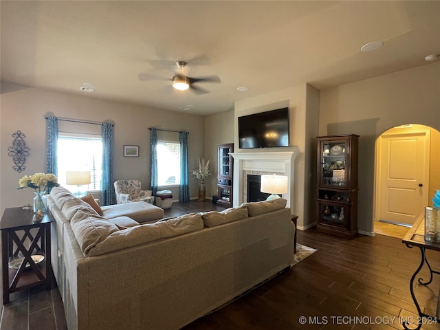 living room with ceiling fan and dark hardwood / wood-style flooring