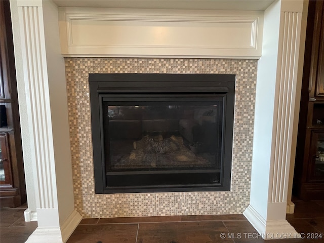 interior details with tile patterned flooring and a tile fireplace