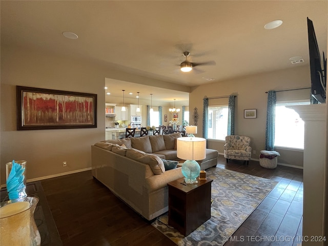 living room with dark wood-type flooring and ceiling fan