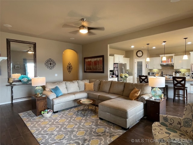 living room featuring dark hardwood / wood-style floors and ceiling fan