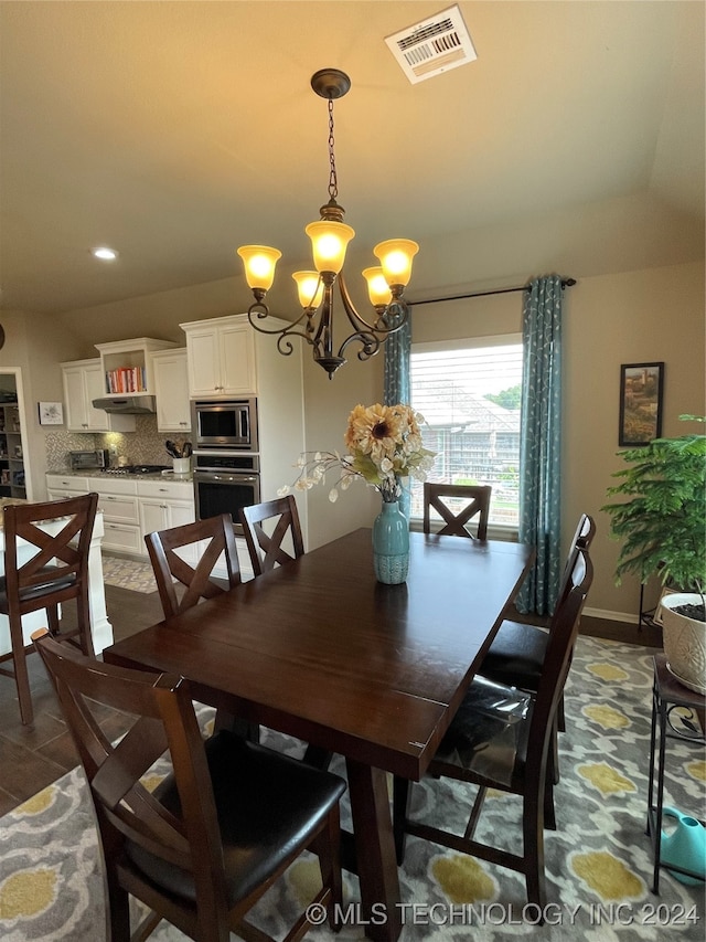 dining area featuring an inviting chandelier