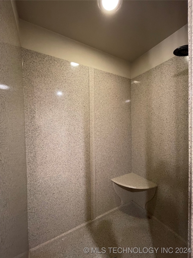 bathroom with a tile shower