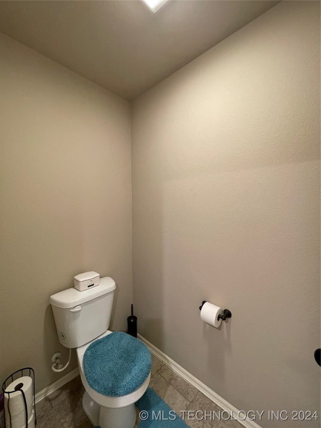 bathroom featuring toilet and tile patterned floors