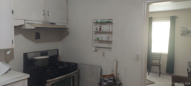 kitchen with black range with gas cooktop and white cabinets