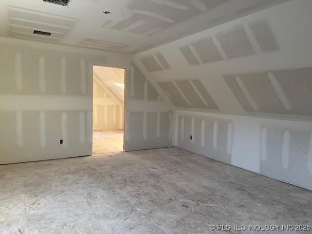 additional living space featuring lofted ceiling