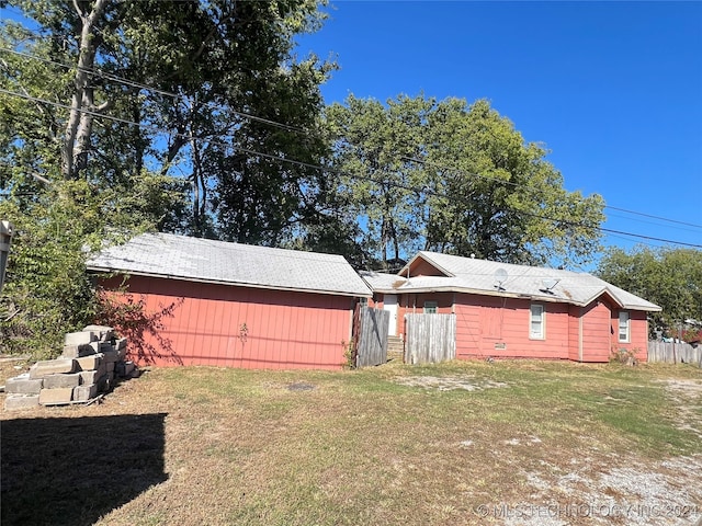 view of side of home featuring a lawn