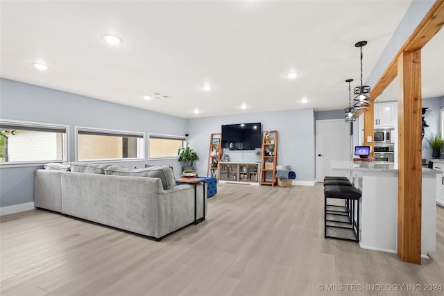 living room featuring light wood-type flooring and plenty of natural light