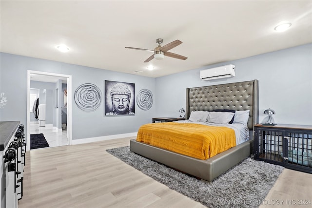 bedroom featuring hardwood / wood-style floors, ceiling fan, and a wall mounted air conditioner