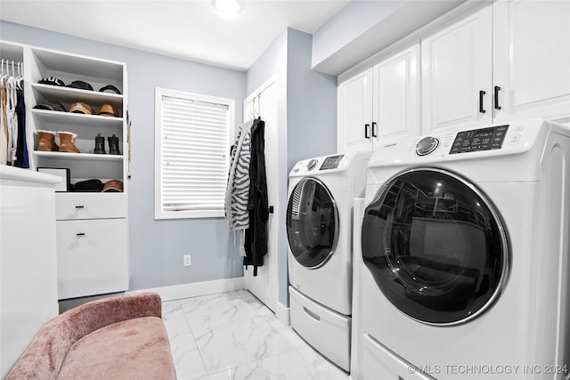 laundry room featuring cabinets and washing machine and clothes dryer