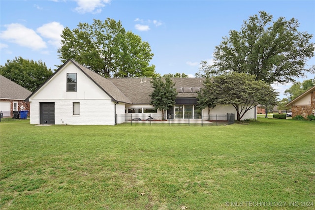 back of house with a yard