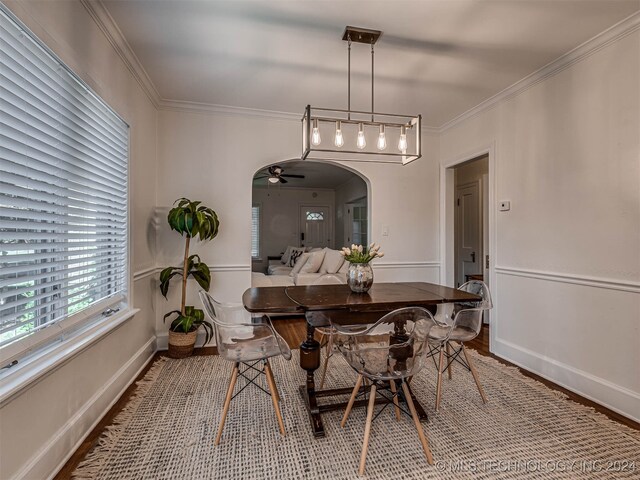 dining area with crown molding, hardwood / wood-style flooring, and ceiling fan