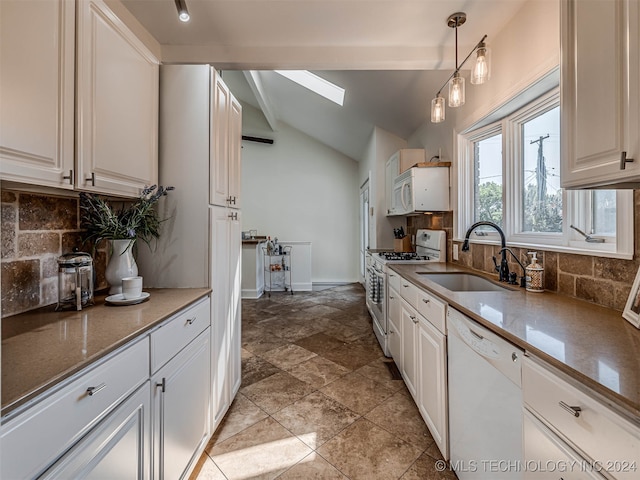 kitchen featuring pendant lighting, vaulted ceiling with skylight, white appliances, and white cabinetry