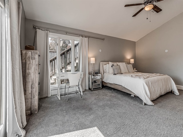 carpeted bedroom with ceiling fan and vaulted ceiling