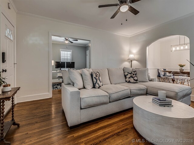 living room featuring ceiling fan, dark hardwood / wood-style floors, and ornamental molding