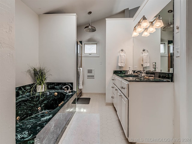 bathroom featuring vanity, a bathing tub, heating unit, tile patterned floors, and vaulted ceiling