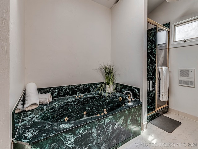 bathroom featuring shower with separate bathtub, tile patterned flooring, and heating unit