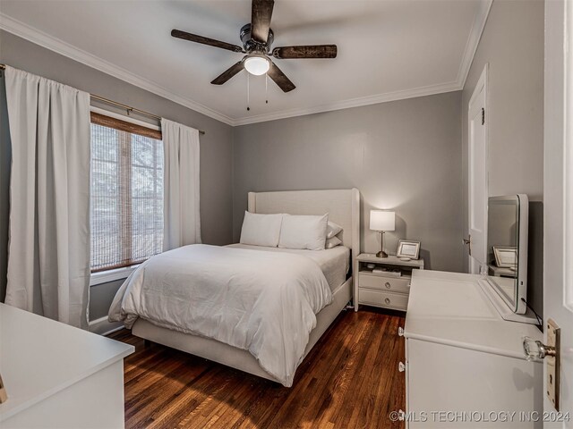 bedroom featuring ceiling fan, ornamental molding, and dark wood-type flooring