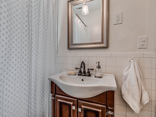 bathroom featuring tile walls and vanity