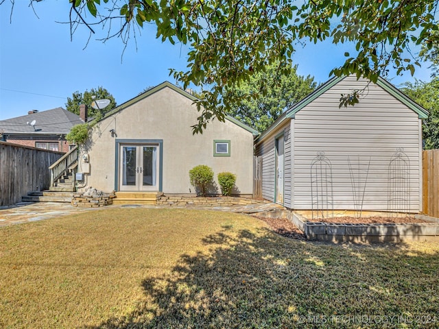 back of house with a lawn