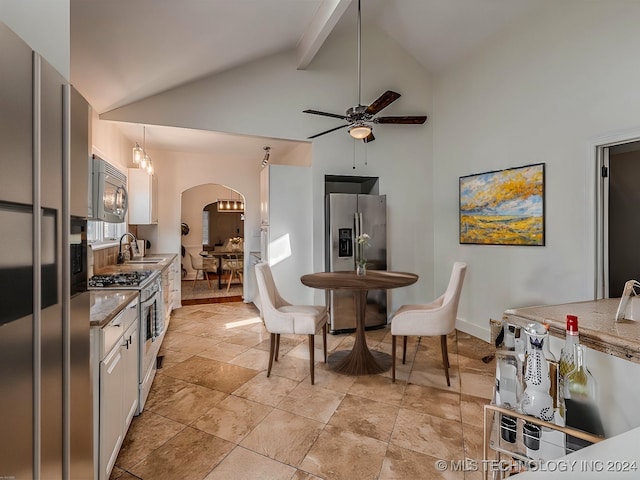 kitchen featuring hanging light fixtures, white cabinetry, sink, and stainless steel appliances